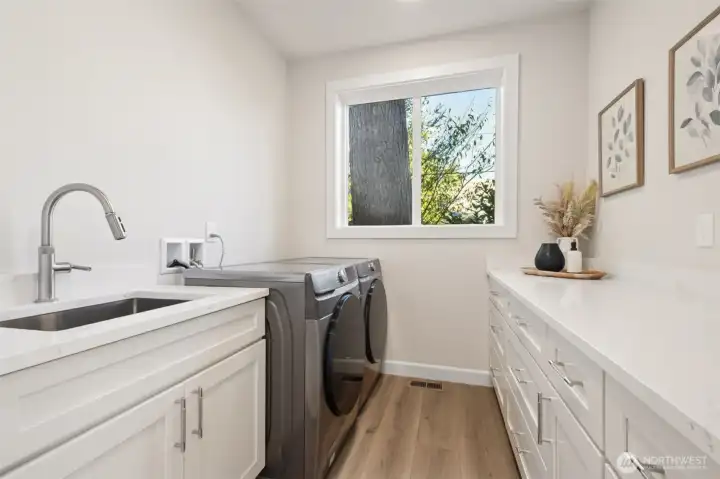 Smartly designed with ample cabinetry, folding counter, and a deep utility sink. It’s a practical yet attractive space that makes laundry day easy and efficient.