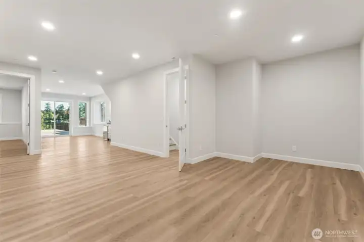 A versatile lower level space is perfect for a media room, play area, or second living area. It’s designed for flexible living and can easily evolve with your needs with an area pre-wired for TV, wet bar with beverage fridge, 4th Bedroom/den/office and an adjacent 3/4 bath. Step out to an expansive deck and out to the lake!