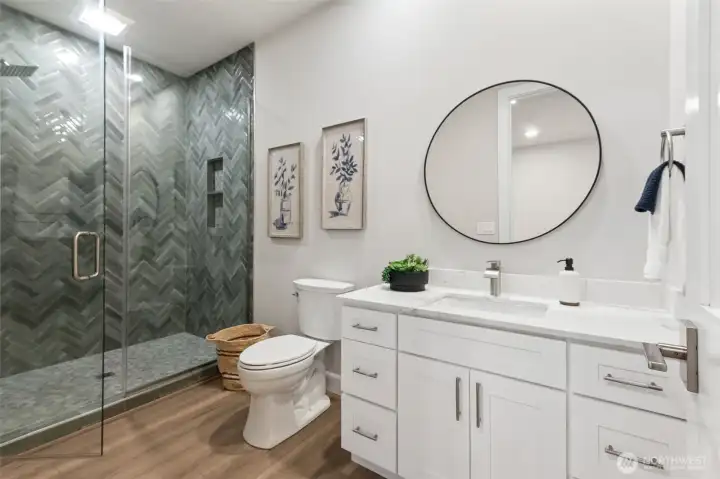 Conveniently located just off the lower level, this well-appointed ¾ bath is ideal for coming in straight from the lake. Its generous layout offers plenty of space to rinse off, refresh, and transition from outdoor fun to indoor comfort. Durable finishes and thoughtful design make it both practical and stylish—perfect for lakeside living.