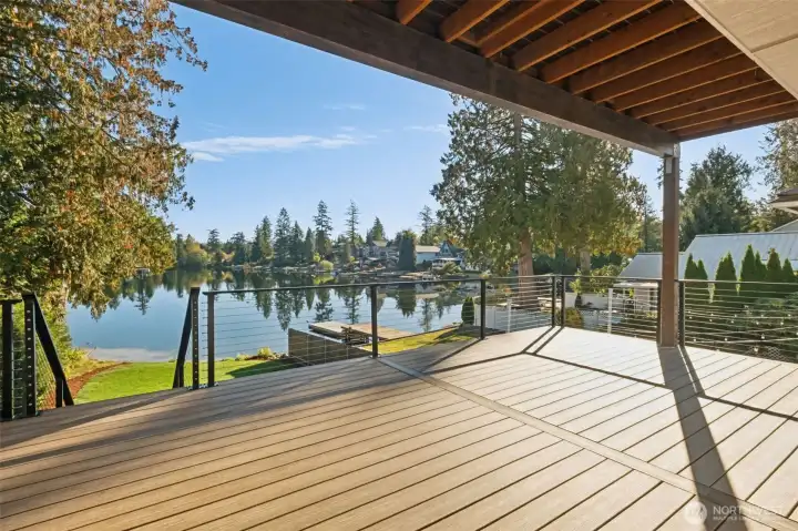 Designed for gatherings large and small, two spacious, entertainment-sized decks offer the perfect setting for outdoor living. There’s ample room for both comfortable seating and full-sized dining furniture, allowing you to host dinners, relax with morning coffee, or unwind at sunset. Overlooking the tranquil waters of Lake Lucerne, this elevated space seamlessly extends the home’s living area and invites you to savor the beauty of lakeside living year-round.