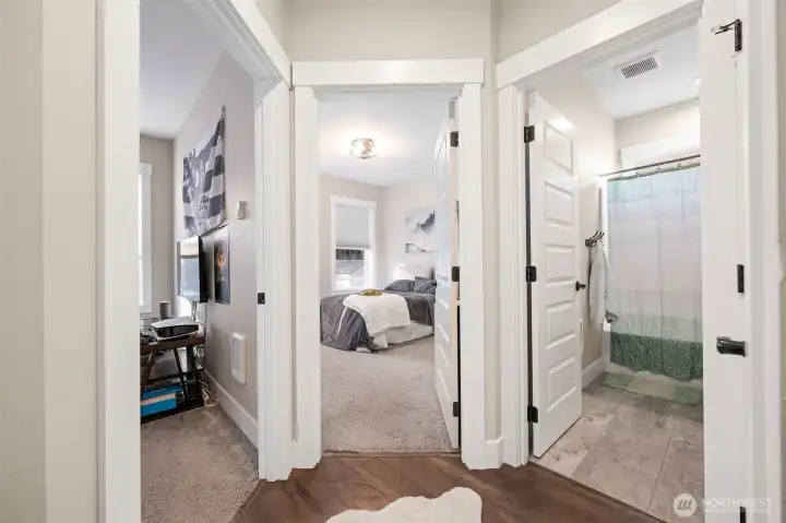 Main floor Bedroom 2, Bedroom 3, and the full bathroom.