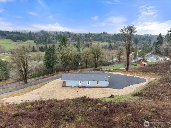 Aerial shot of the back side of the home.  Door leads to the utility room.