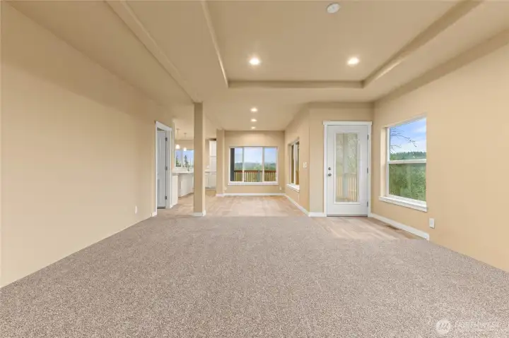 Another view of the spacious dining area with large windows, which allows more light and views of valley below.  Door to the left leads to the utility room.