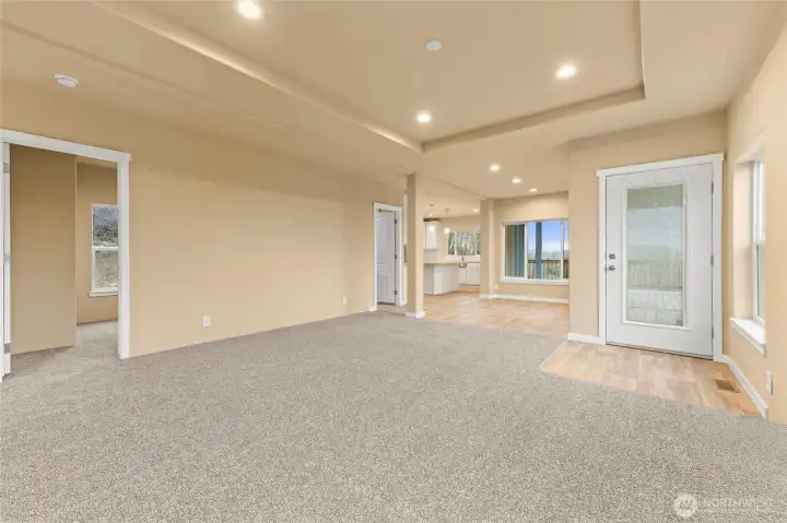 This shot from the living room shows door to the left is the first guest room, and door two by the kitchen is the utility room.