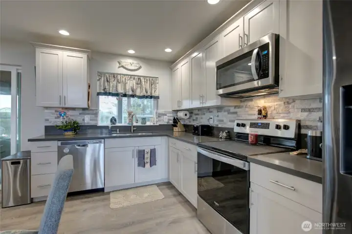Quartz countertops and stainless steel appliances.