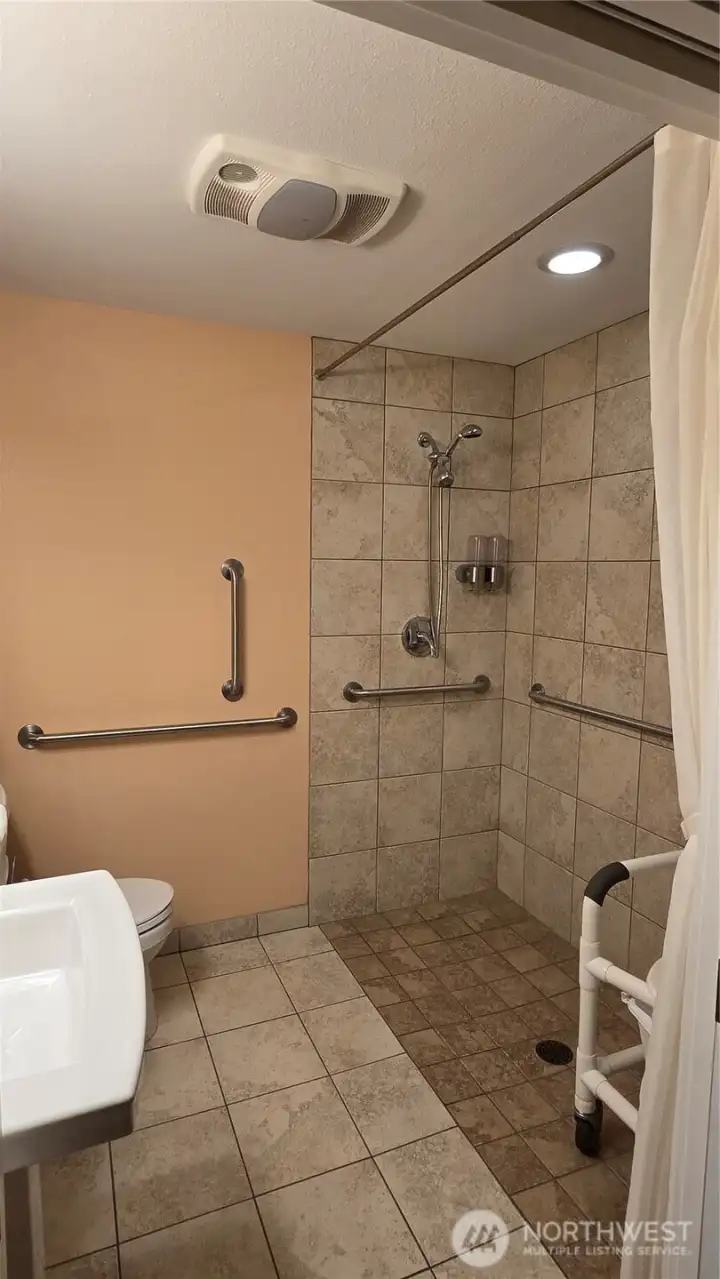 Large hallway bathroom upstairs with roll in shower