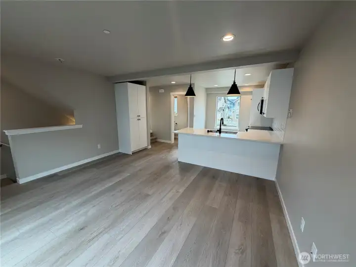 Subject property. Open kitchen/living floor plan. Kitchen pantry to left