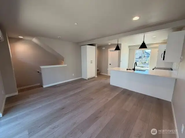 Subject property. Open kitchen/living floor plan. Kitchen pantry to left