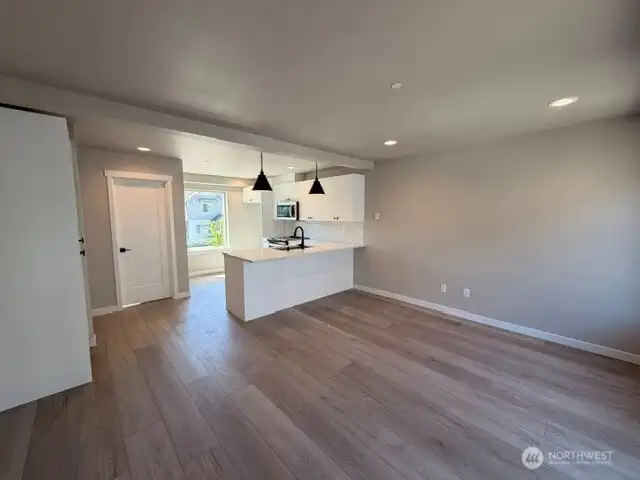 Subject property. Open kitchen/living floor plan. Door to the left is the powder room