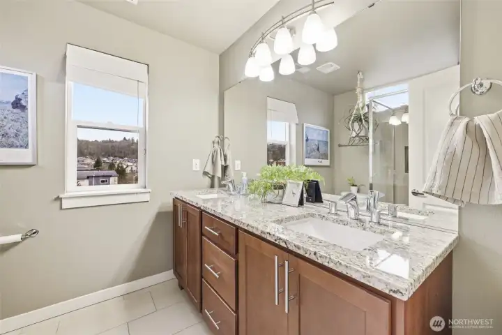 Primary en-suite bath with double sink vanity and warm neutral tones.
