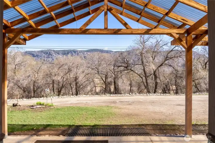 Covered patio standing at the front door, facing East
