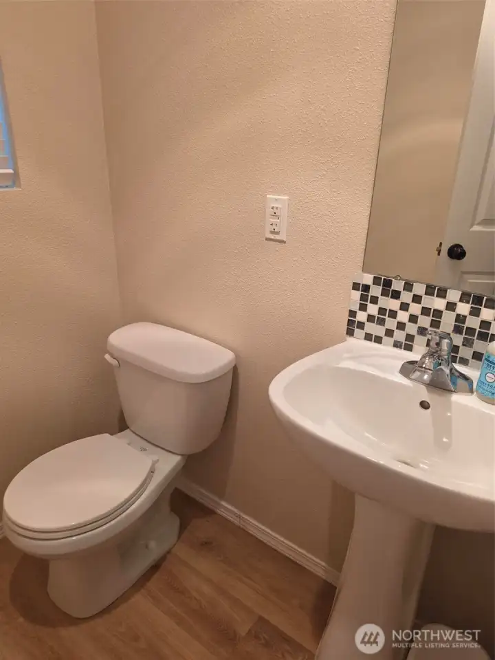 Main Floor 1/2 bath by entry door. Main Floor 1/2 bath by entry door.