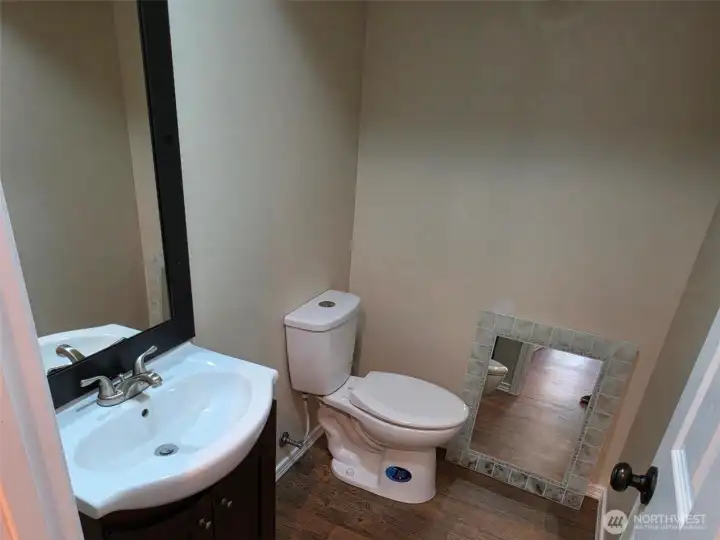 Family Room 1/2 bath with an extra mirror. Family Room 1/2 bath with an extra mirror.
