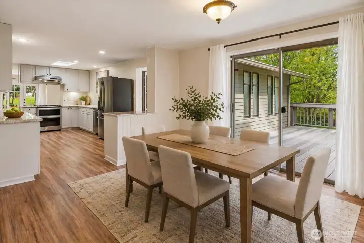Beyond the parlor is a dining area open to a slider to the deck and kitchen...(virtually staged) Beyond the parlor is a dining area open to a slider to the deck and kitchen...(virtually staged)