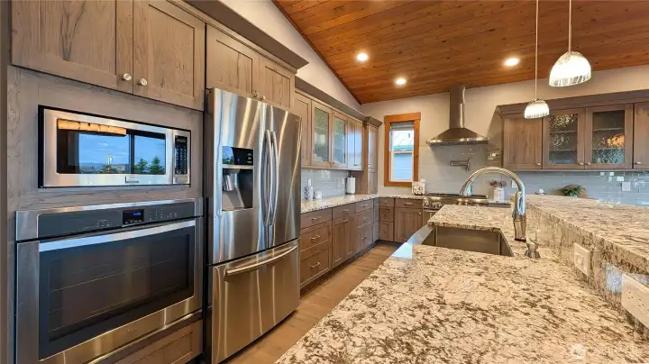 Chef's kitchen with expansive counters and nicely appointed with lovely upgrades.