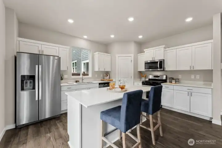 Stainless steel appliances throughout kitchen. Photo rendering is representational and may be virtually staged. Actual home is under construction and finishes, elevation, and paint colors may vary. See site agent for details. Stainless steel appliances throughout kitchen. Photo rendering is representational and may be virtually staged. Actual home is under construction and finishes, elevation, and paint colors may vary. See site agent for details.