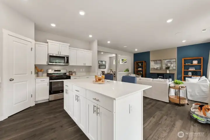 Kitchen island with hard-surface counters. Photo rendering is representational and may be virtually staged. Actual home is under construction and finishes, elevation, and paint colors may vary. See site agent for details. Kitchen island with hard-surface counters. Photo rendering is representational and may be virtually staged. Actual home is under construction and finishes, elevation, and paint colors may vary. See site agent for details.