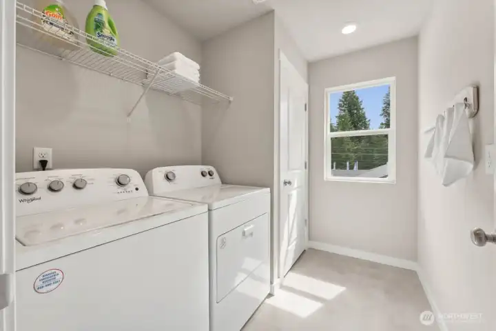 Utility room upstairs with window. Photo rendering is representational and may be virtually staged. Actual home is under construction and finishes, elevation, and paint colors may vary. See site agent for details. Utility room upstairs with window. Photo rendering is representational and may be virtually staged. Actual home is under construction and finishes, elevation, and paint colors may vary. See site agent for details.