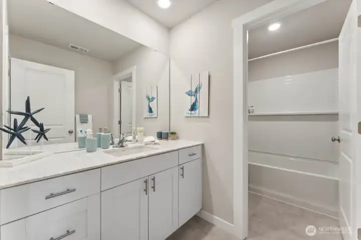 Hallbath. Photo rendering is representational and may be virtually staged. Actual home is under construction and finishes, elevation, and paint colors may vary. See site agent for details. Hallbath. Photo rendering is representational and may be virtually staged. Actual home is under construction and finishes, elevation, and paint colors may vary. See site agent for details.
