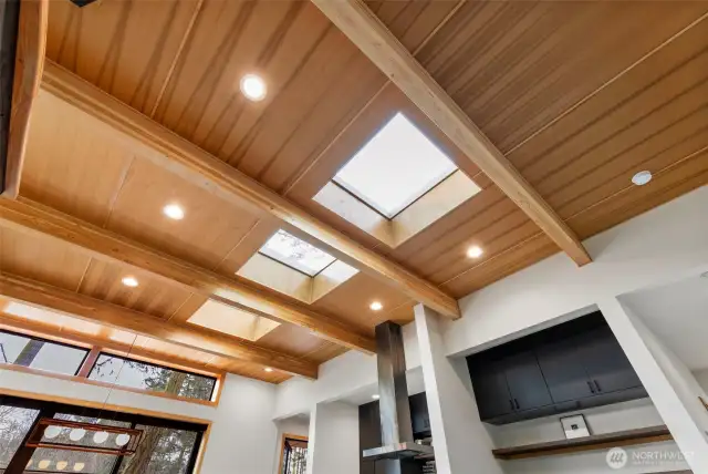 Gorgeous Fir-lined ceiling with exposed beams as well as deeply inset opening skylights provide softly filtered light during the day and star-gazing at night.