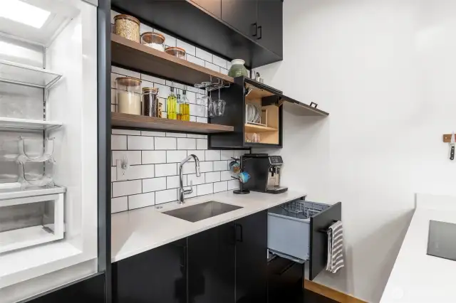 This space is designed to make use of every inch; with a streamlined dishwasher drawer, built-in refrigerator/freezer and soft-close cabinets. Designer backsplash and fixtures add the finishing touch.