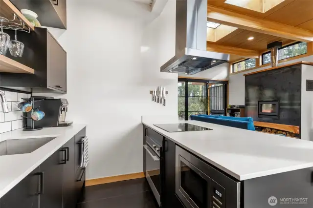 High-end induction cooktop, hood vent, roomy oven and built-in microwave are installed so everything is within reach at all times. With windows all around there is always ample natural light!