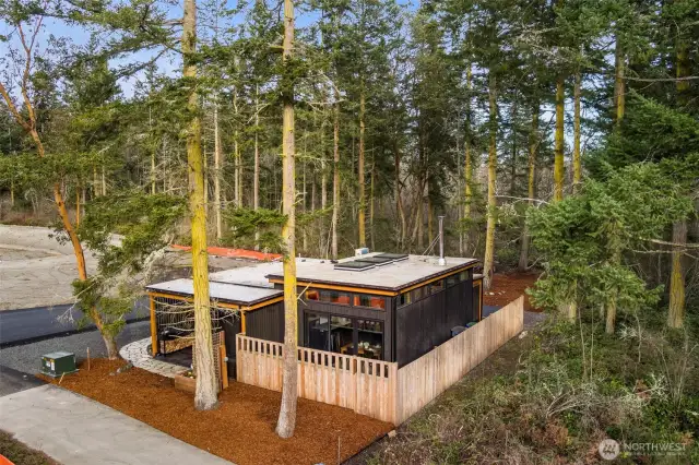 Nestled on a beautiful private lot, with trees on three sides and partially fenced for privacy. Flat roof is TPO Roofing Membrane, energy efficient and sustainable, with 25-year lifespan.