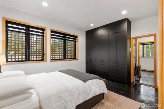 Custom closet stretches across the back wall and to the ceiling, providing plenty of storage options.