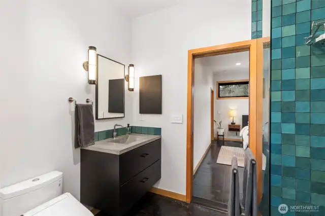 The 3/4 bath is fitted with every comfort, from the Toto toilet/bidet to the heated floors. Nativestone countertop and designer sconces add beauty.