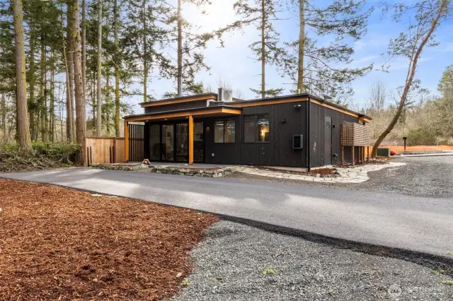 A  look at the back of the home, with the utility/storage closet on the wall on the right. Look closely on the back wall for the EV car charger!