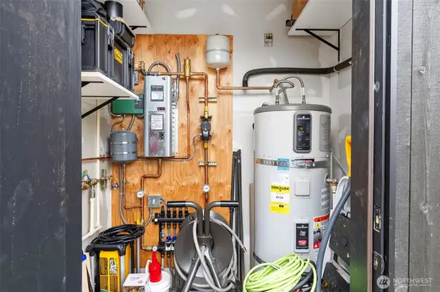Outside the home, the utility closet houses the heat pump HW heater and fixtures for radiant floor heat.