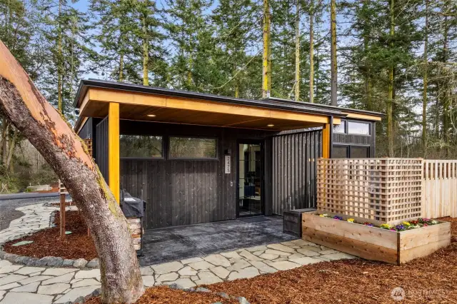 Follow the meandering slate path to the covered entrance of the home. Ring security system installed for your peace of mind, and Smart lighting featured inside and out.