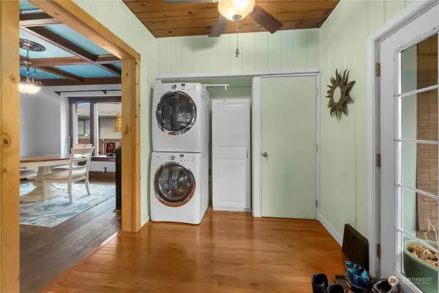 Showing the laundry location  in the kitchen. Dining room is on the left. French doors on the right open onto the back deck.