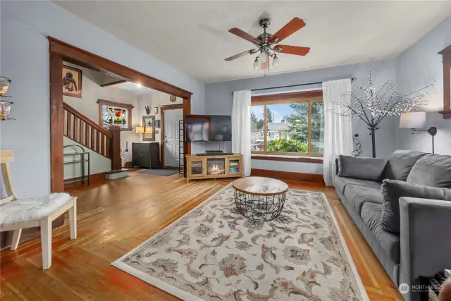 Looking back toward the entry, stairway to upper level, and the main level bathroom is to the left of the stairs.