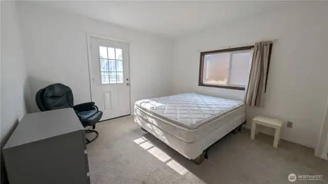 Primary bedroom with exterior door to small deck.