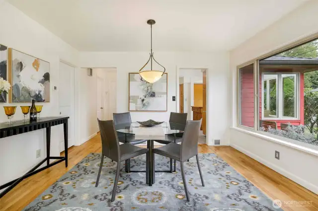 Spacious formal dining room seamlessly connected to the kitchen, featuring natural light and plenty of room for hosting dinner parties or everyday family meals in this Broadview beauty.