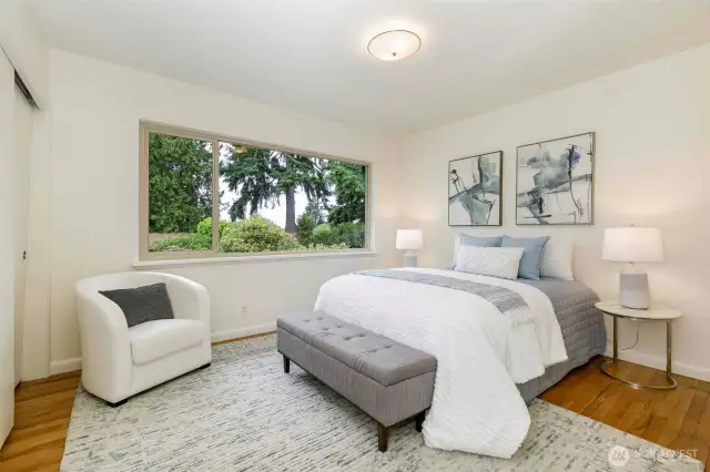 Two light-filled main-floor bedrooms with hardwood floors, generous closets, and easy access to a full bath—comfortable and quiet retreats in this peaceful Broadview neighborhood.