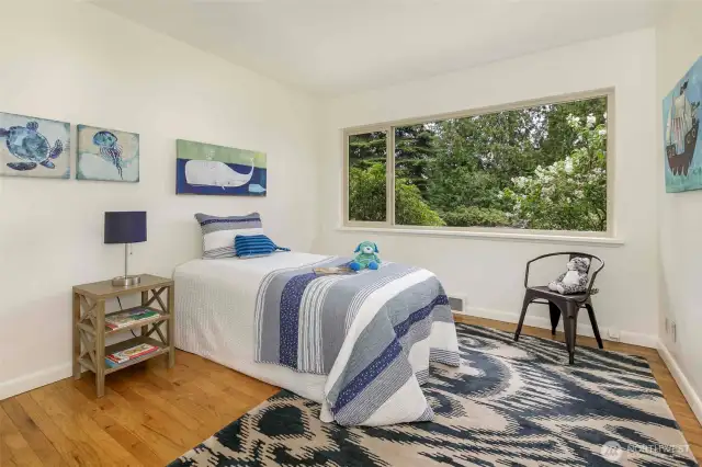 Two light-filled main-floor bedrooms with hardwood floors, generous closets, and easy access to a full bath—comfortable and quiet retreats in this peaceful Broadview neighborhood.