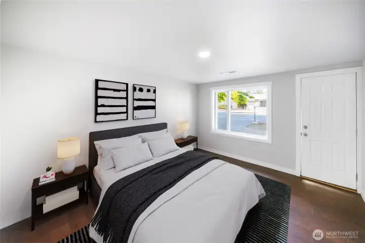The spacious primary suite features oversized windows, sleek LVP flooring, and a clean modern feel — your ideal spot to relax and recharge. *virtually staged*