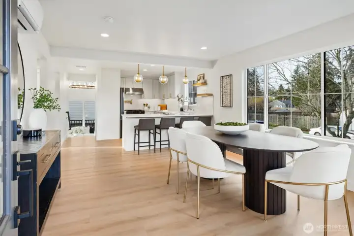 Enter into bright open concept space illuminated by expansive colonial style grid windows