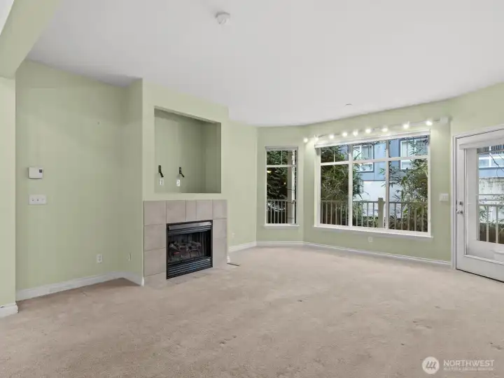 The spacious living room gives access to the balcony. Prop open the door and listen to the birds chirp.