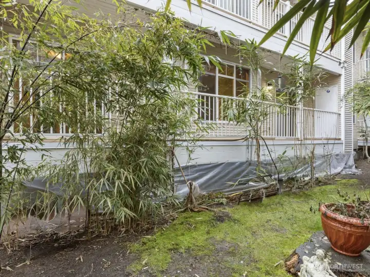Just outside the unit is a lush garden space providing privacy from the neighboring building.