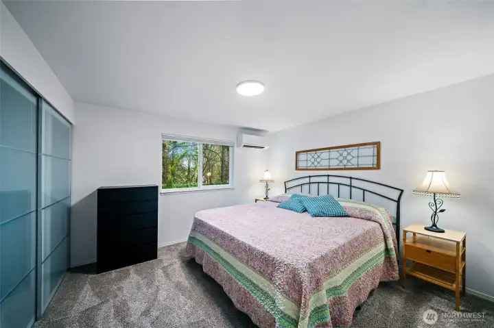 Bedroom number one sports a king size bed and plenty of room to hold it, and more!  Glass doors on the closet offer light and a modern aesthetic