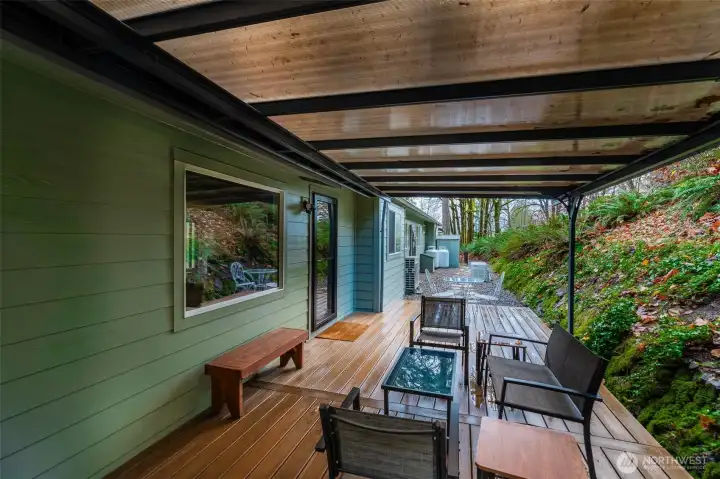 Cozy covered Trex deck is easy care, usable year 'round and located off of the living room and kitchen. Use the kitchen window as a handy pass through while entertaining friends and family back here