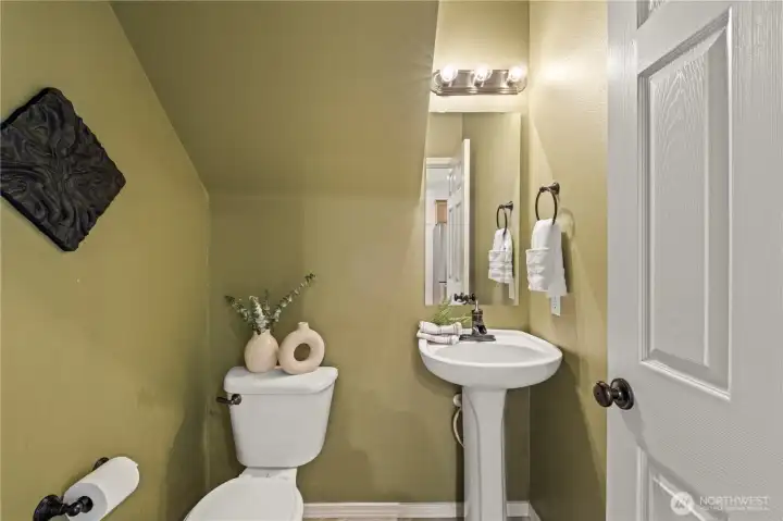 Half bath on the main level has a brand new floor