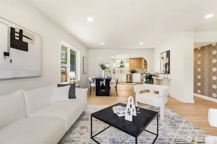 An open concept design that creates a seamless connection between living, dining, and kitchen spaces.