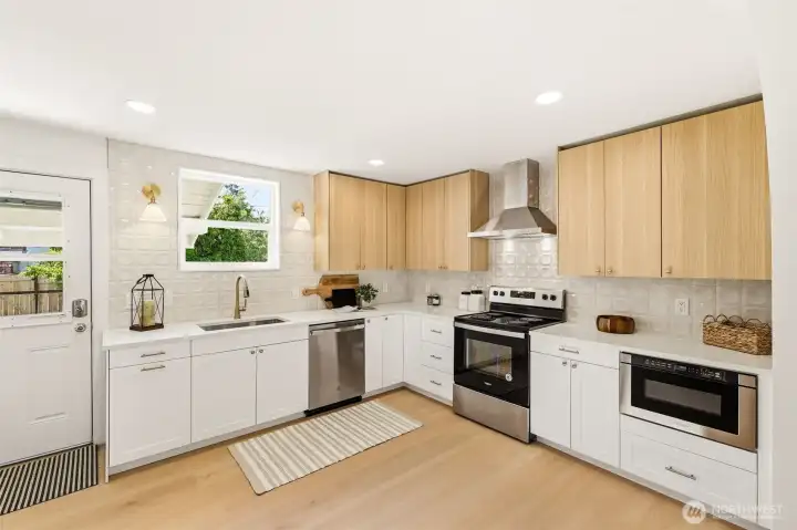 A fully updated kitchen featuring quartz countertops, custom cabinetry, and modern finishes throughout.