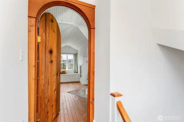 Arched door to primary bedroom