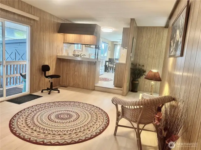 Sitting room or den? Use your imagination! So much light, it would make a beautiful library of office area.