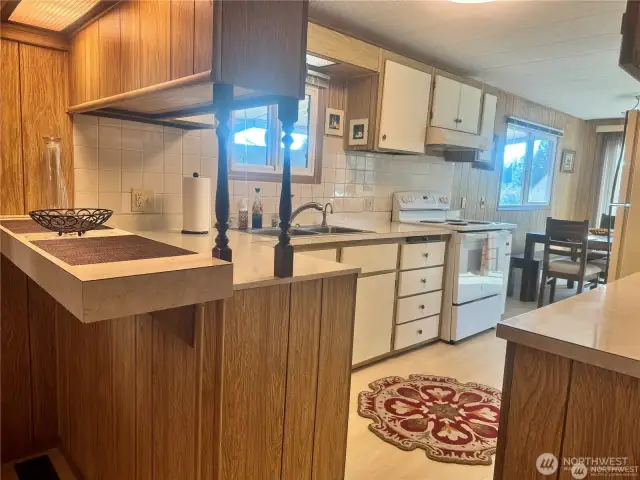 The kitchen has its own breakfast bar.